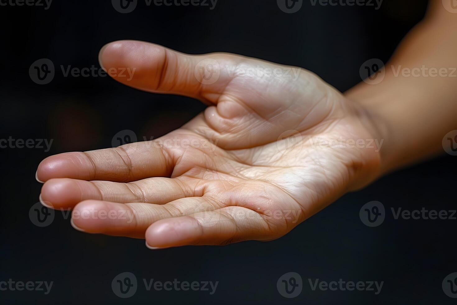 Open Hand Gesture on Dark Background for Support, Help, and Giving Concepts photo