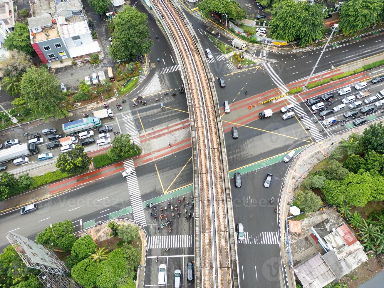 Jakarta Intersection with Elevated Train Tracks and Traffic, Aerial Drone Shot photo
