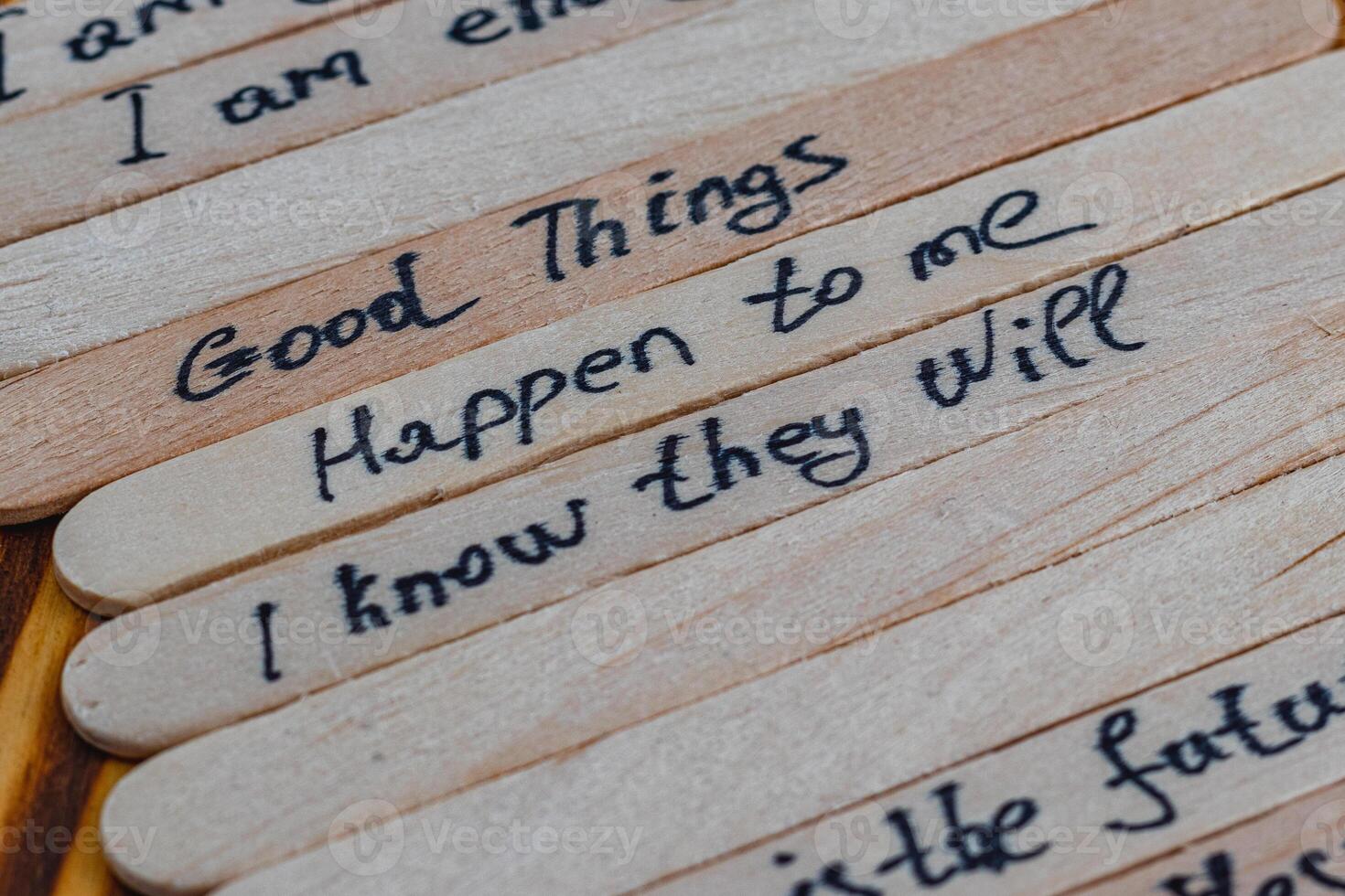Positive thoughts for self esteem on wooden sticks on a wooden table photo