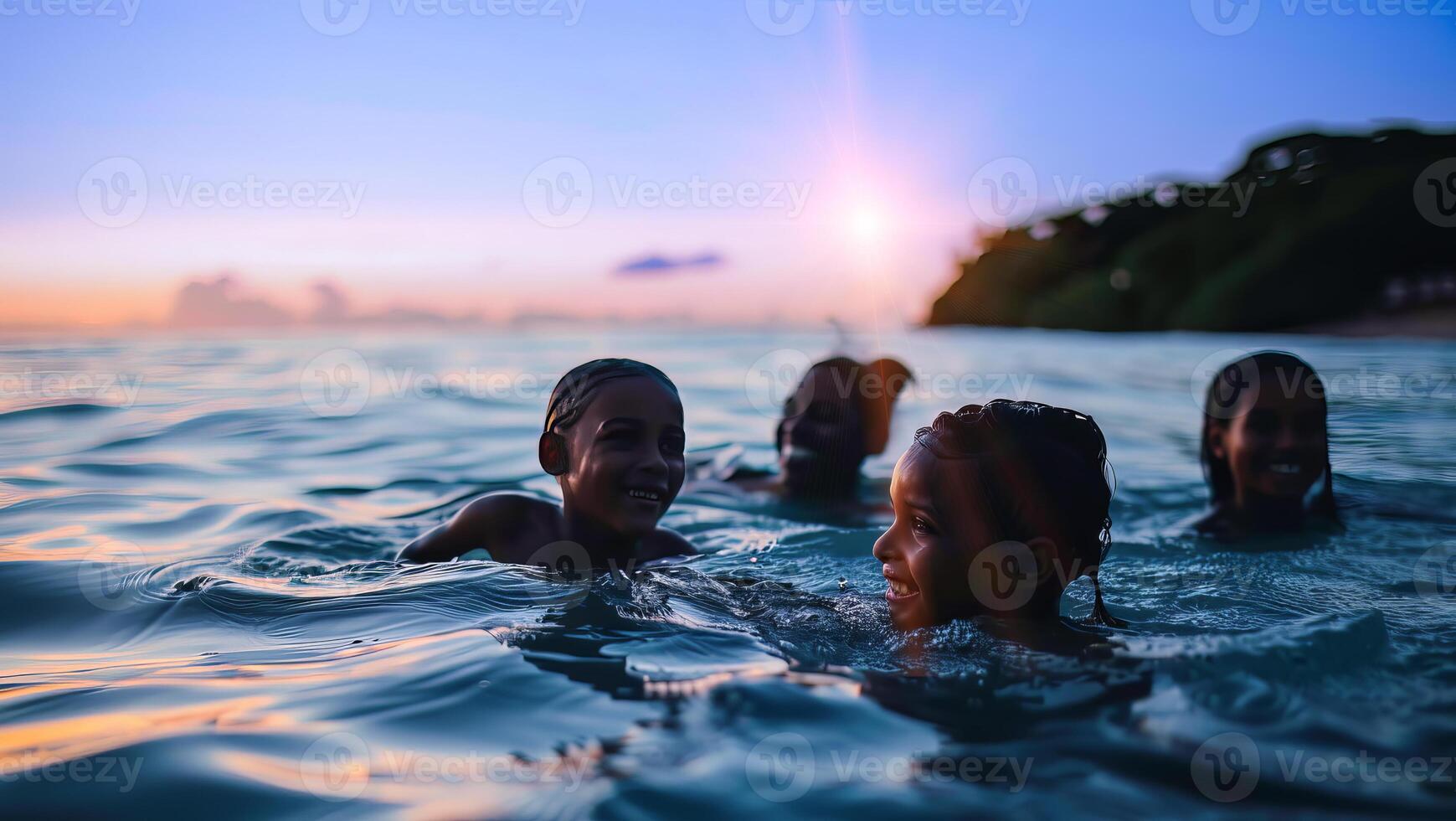 Family and group of children swimming at the ocean on the vacation at sunset at the resort photo