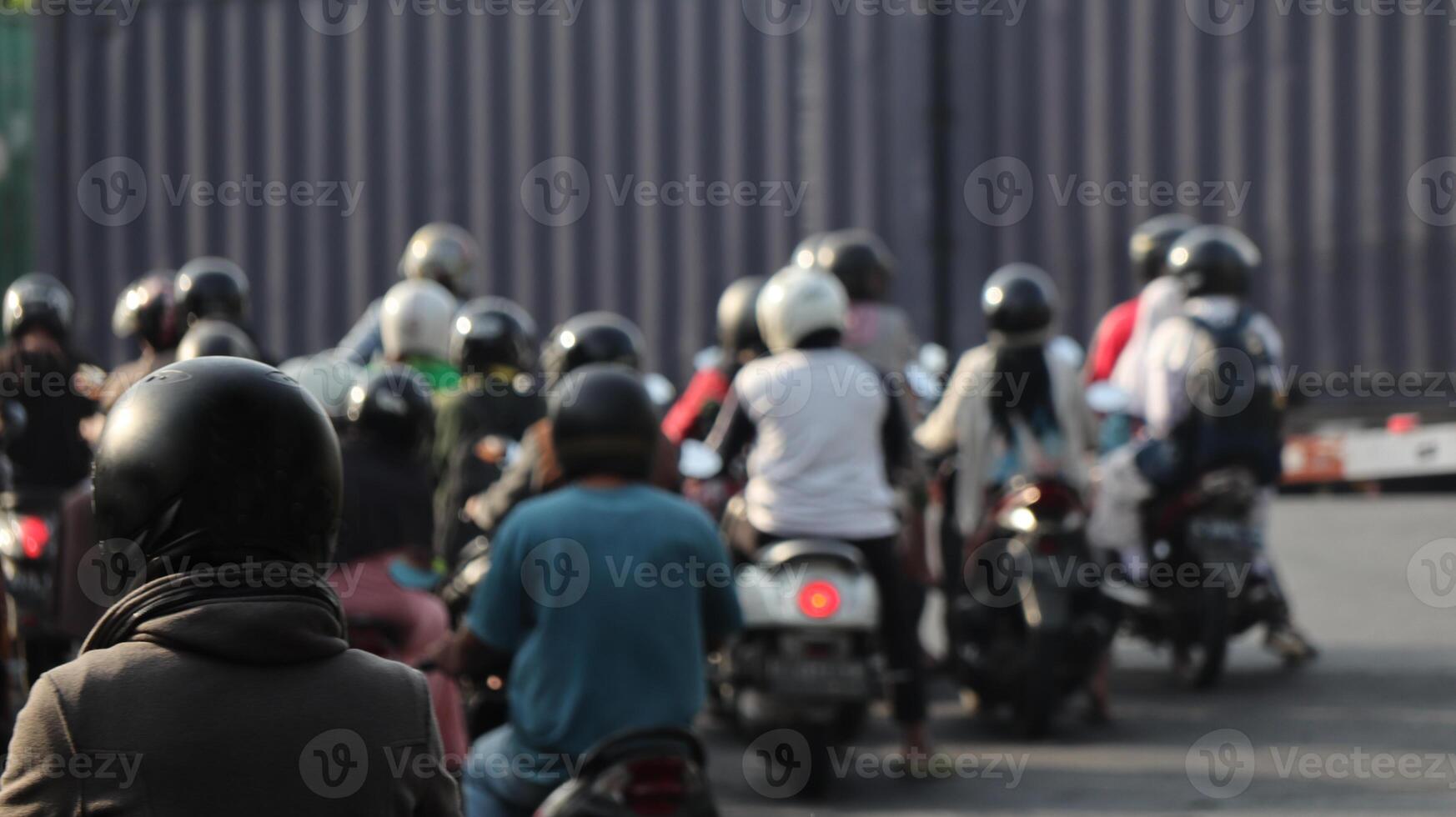 Blur crowd of vehicles queues waiting for a train to pass photo
