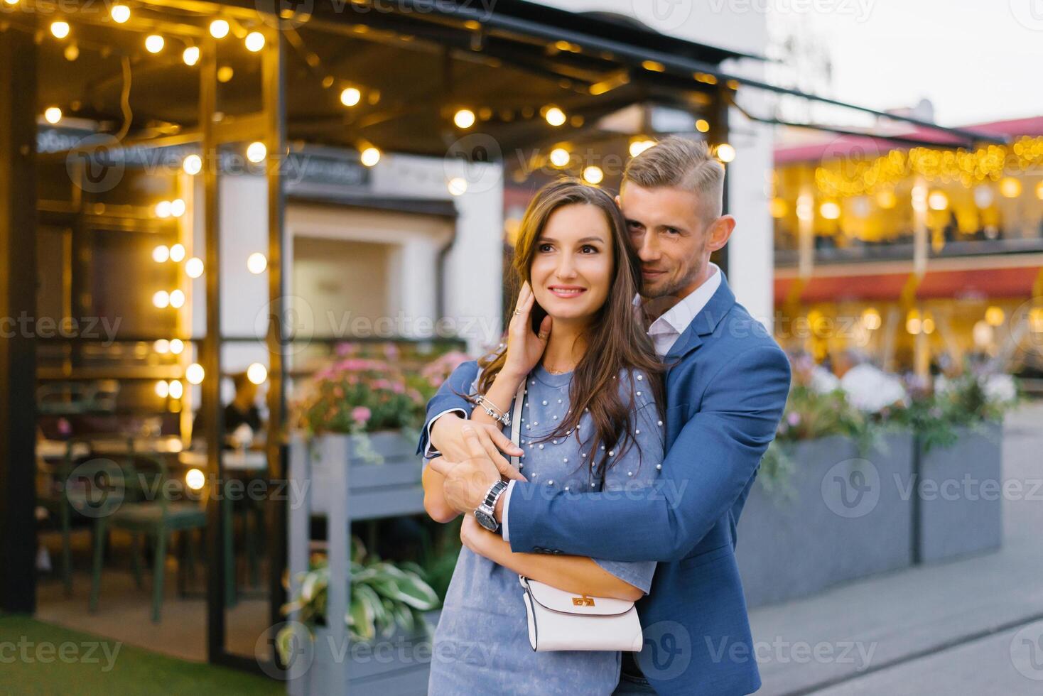 Young stylish couple in love walks around the city in the summer photo