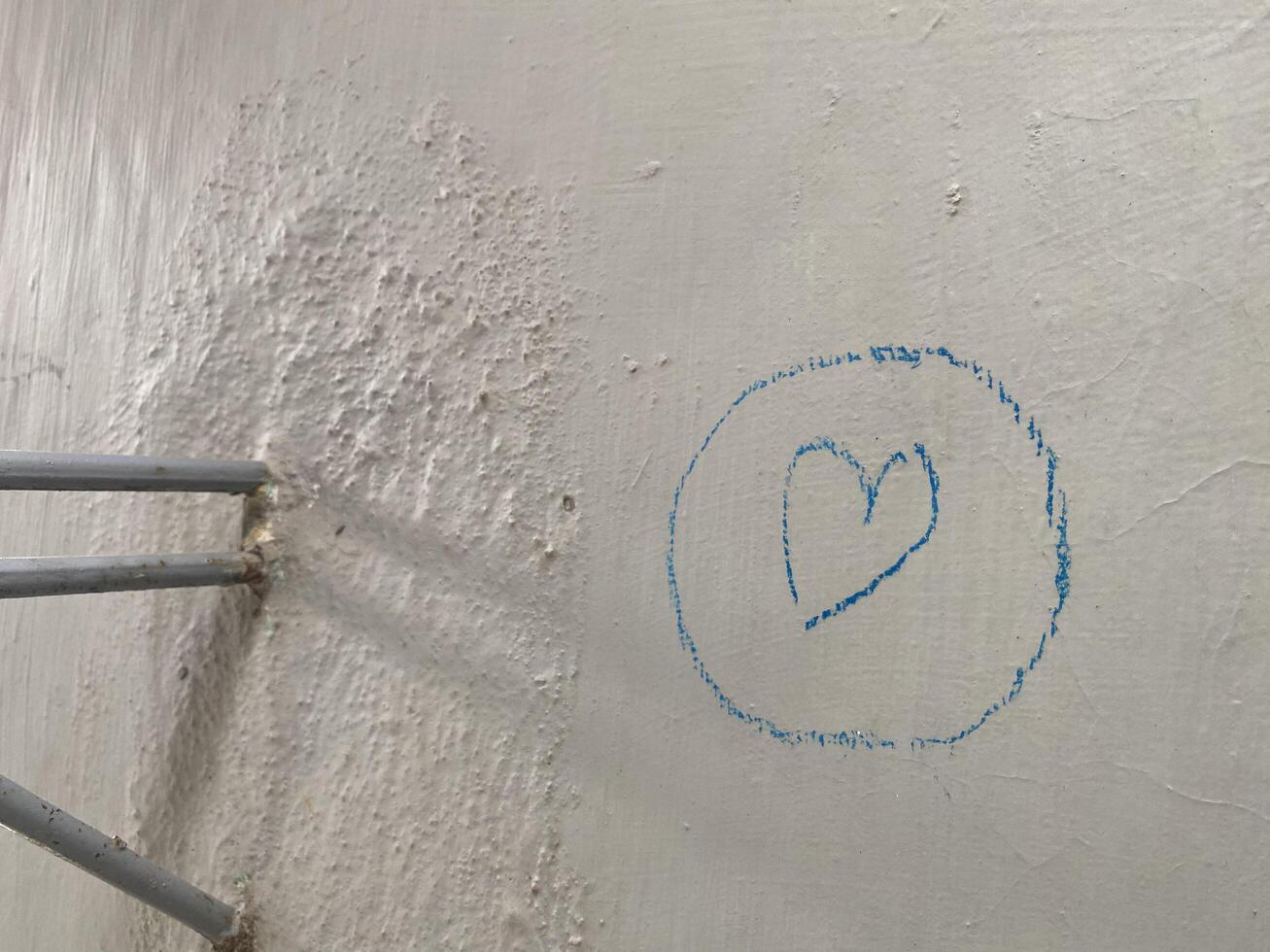 Crayon scribbles in the shape of love on a wall photo