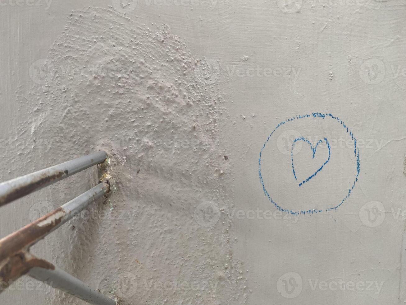 Crayon scribbles in the shape of love on a wall photo