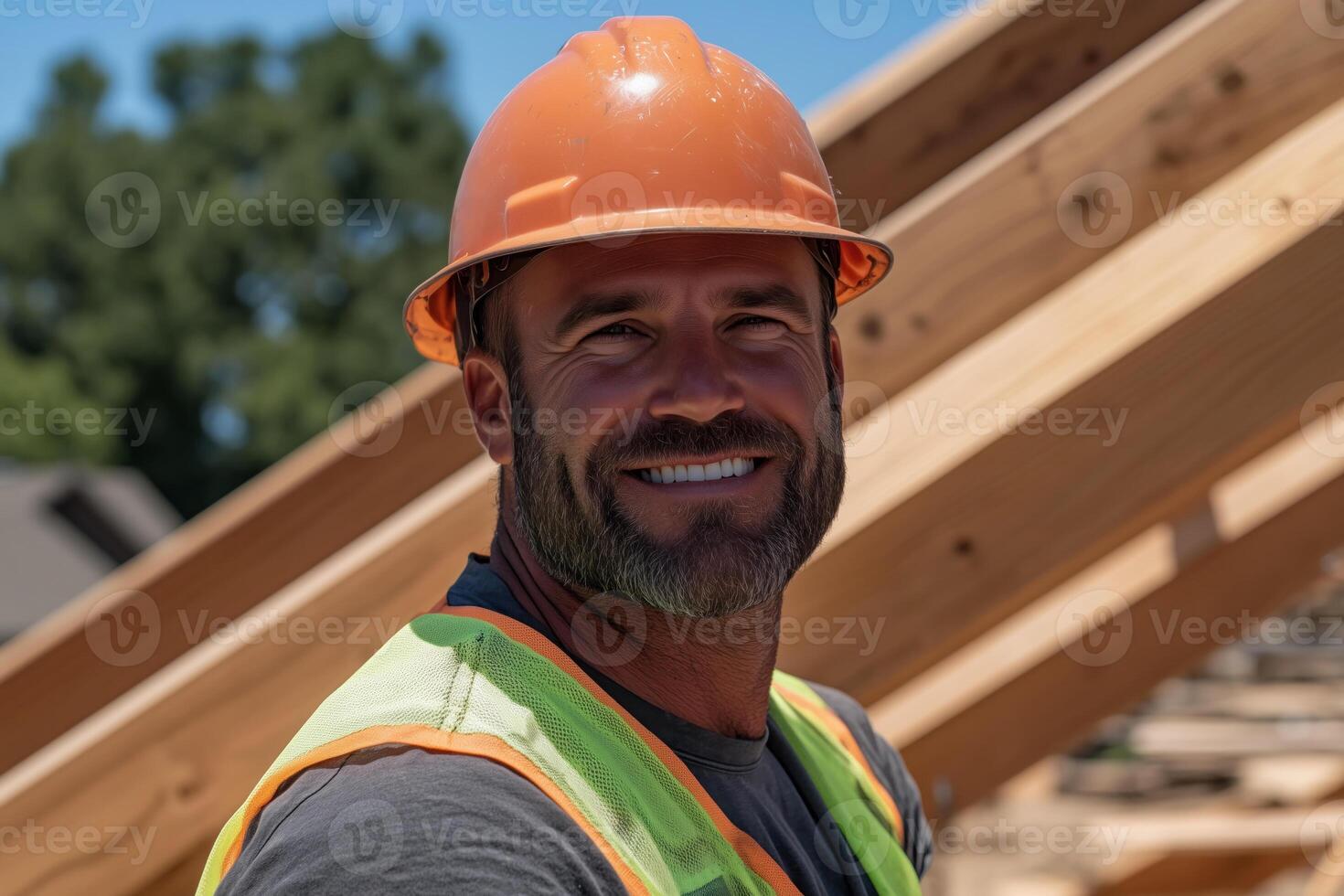 Portrait of a smiling worker on a roof of a new wooden house under construction photo