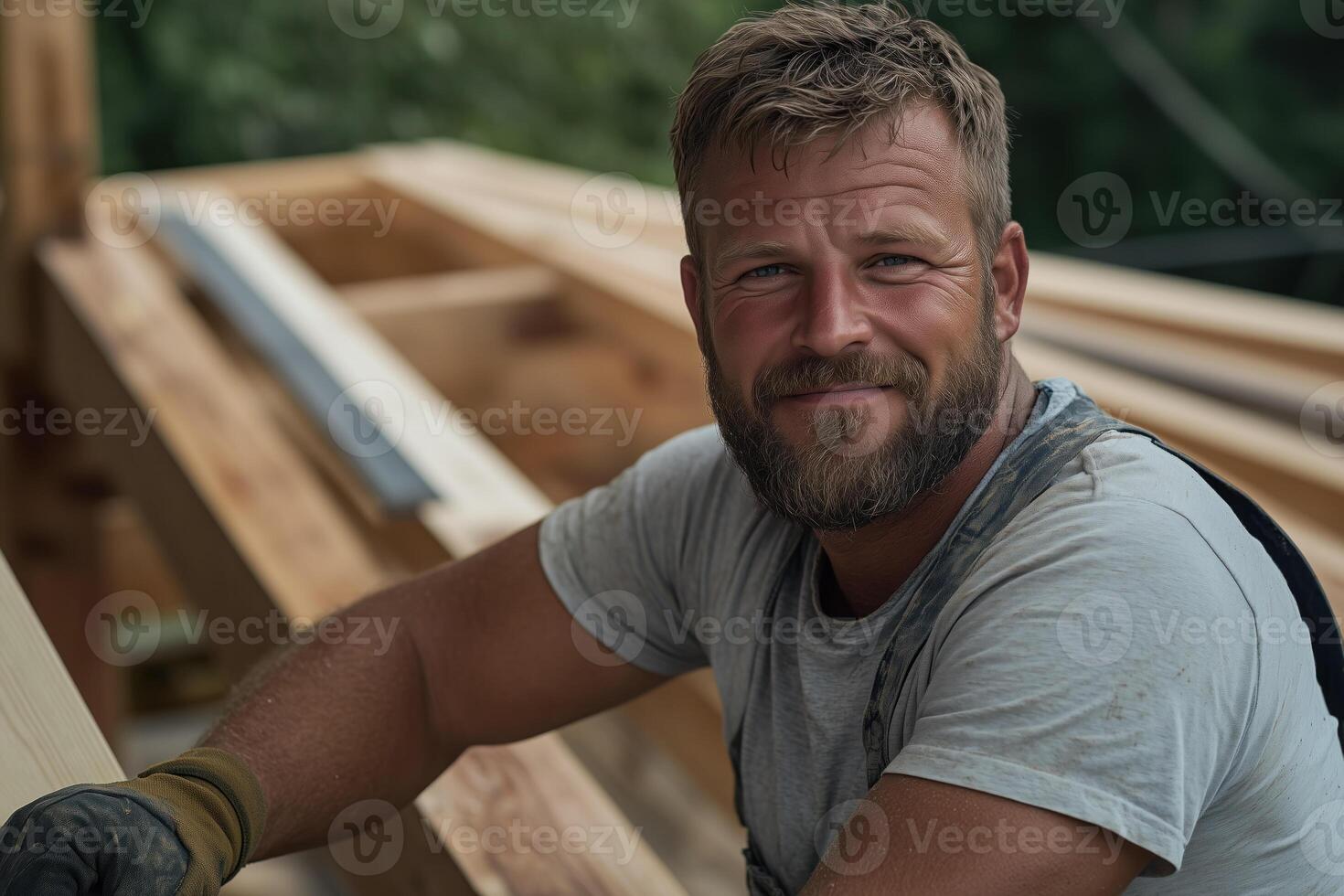 Portrait of a handsome carpenter working on a wooden construction site photo