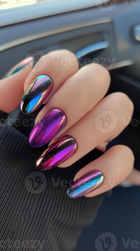 Close-up of multicolored chrome nails with holographic effect. Glossy manicure and modern nail art photo