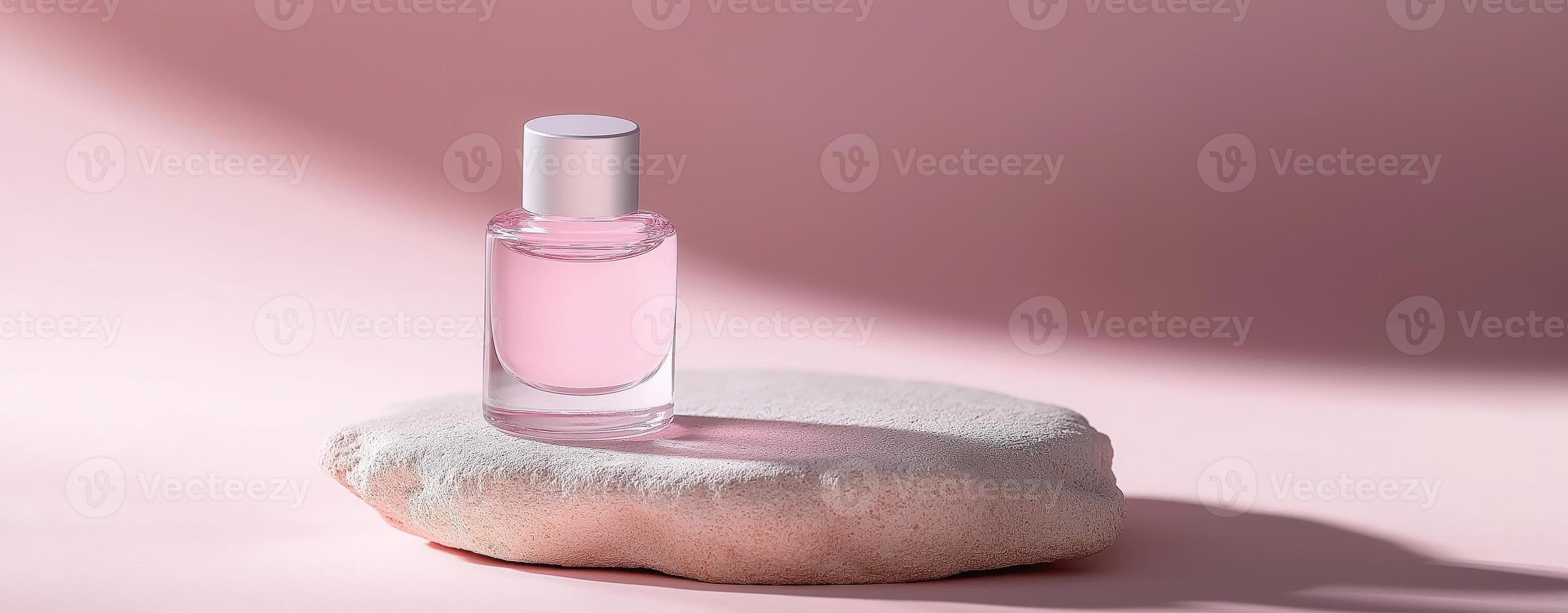 Pink nail polish bottle on stone, minimalist beauty concept, professional manicure, cosmetic display photo