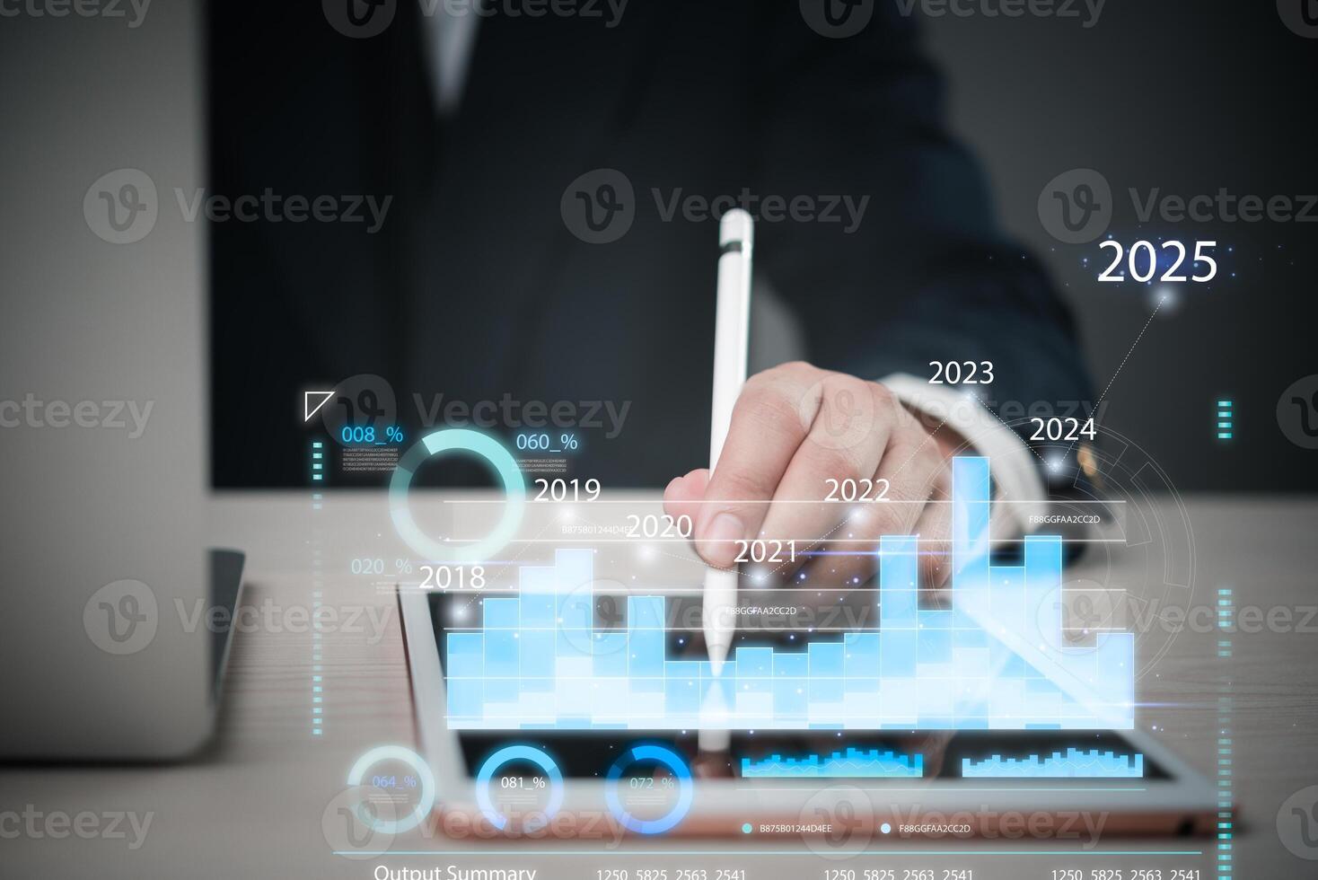 Businessman using tablet to make graphs and charts photo