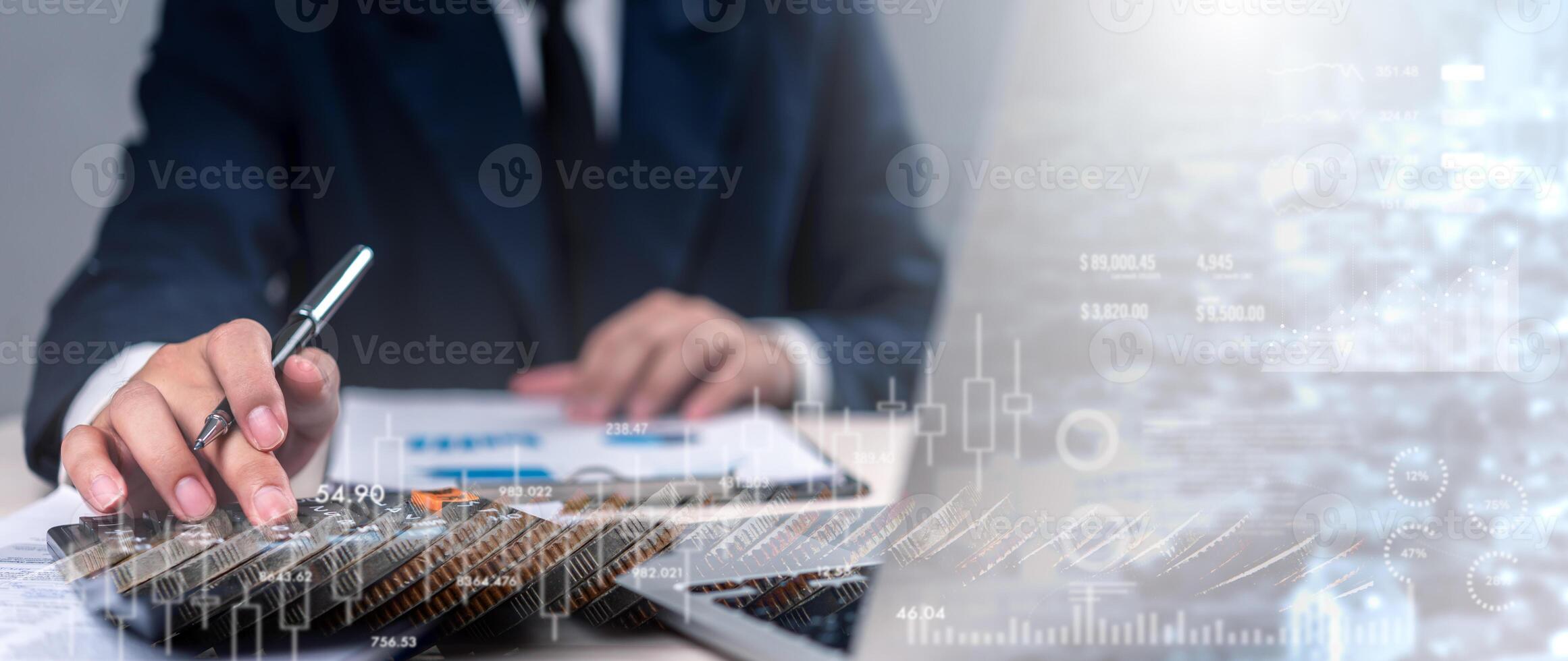 A man in a suit is writing on a piece of paper photo