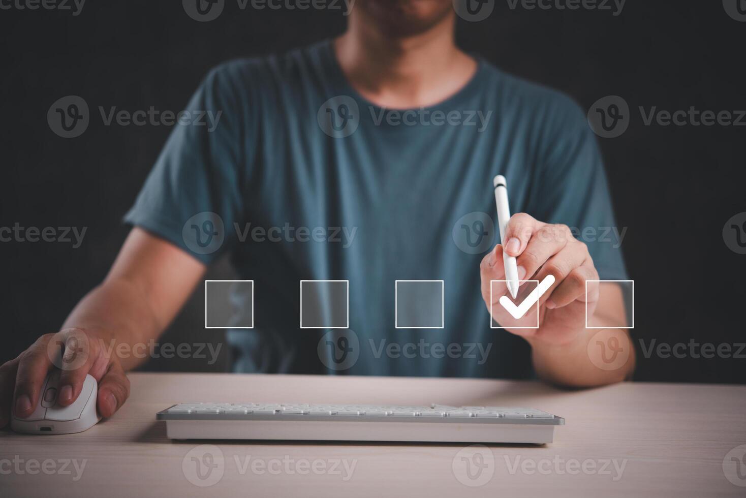 Man writing check mark on computer keyboard photo