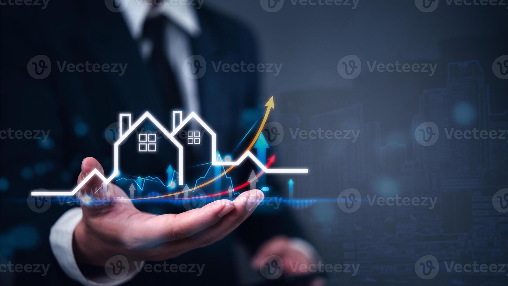 Businessman holding house and house symbol on city background photo