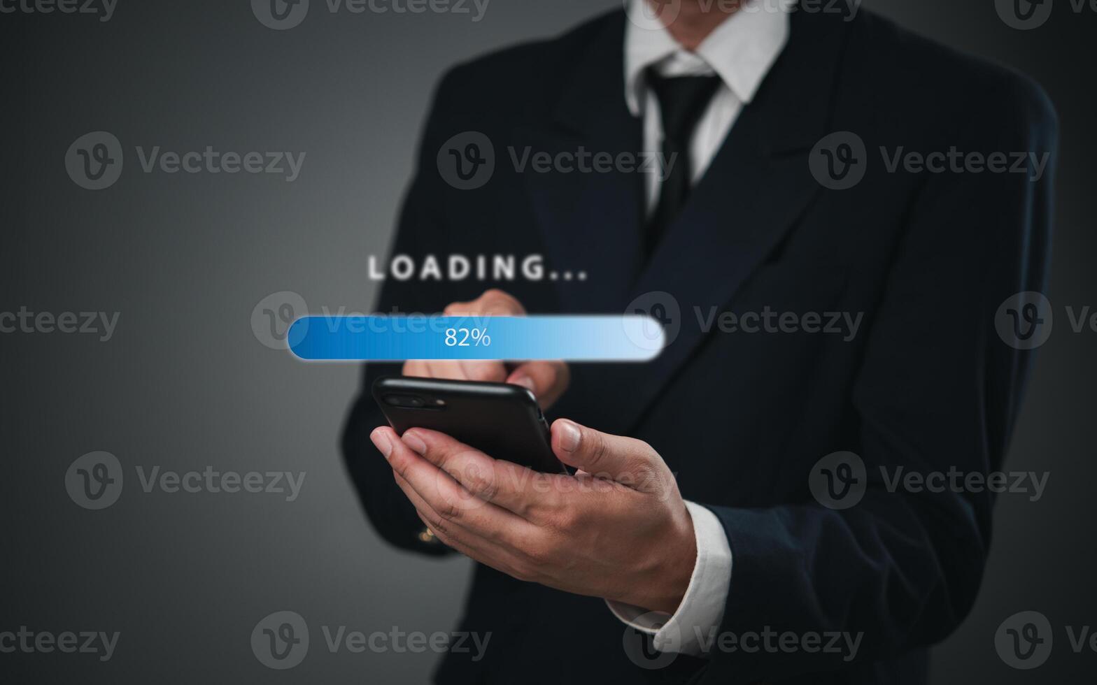 Businessman holding smartphone with loading button photo