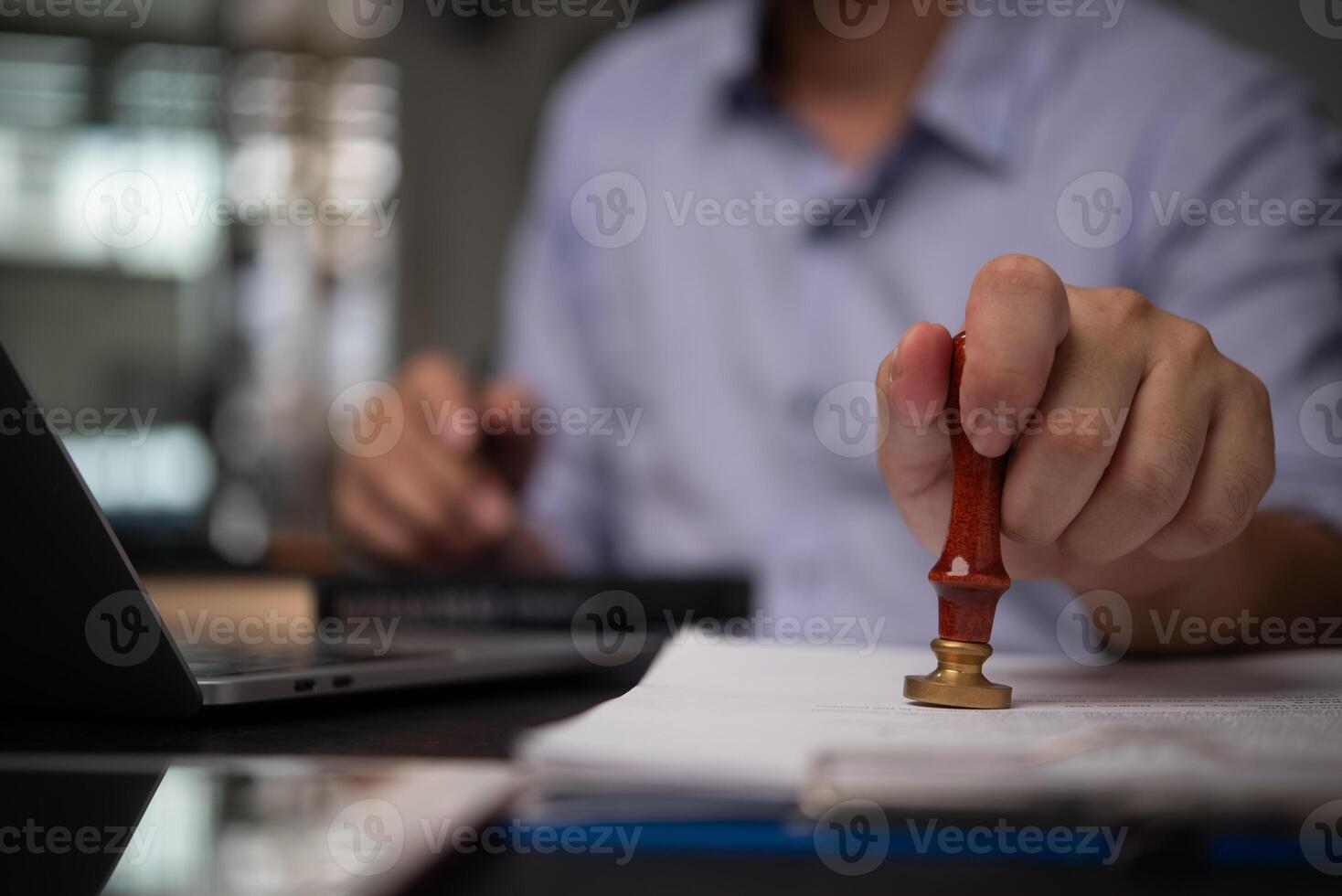 A person holding a pen and writing on a piece of paper photo