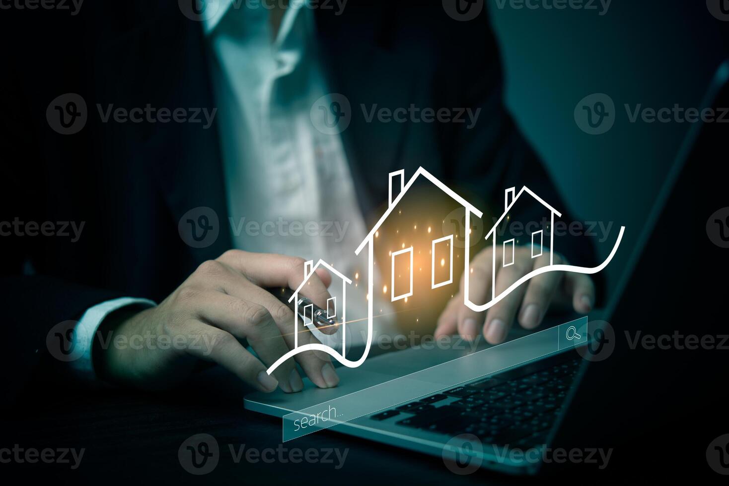 A man in a suit is using a laptop to show a house on the screen photo