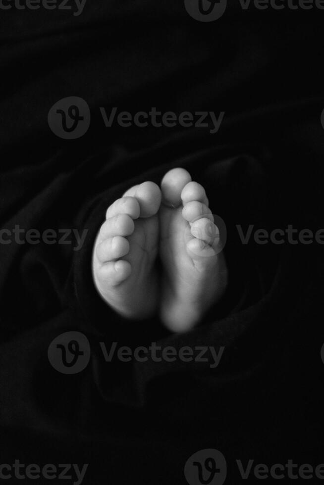 A black and white photo of a baby's feet