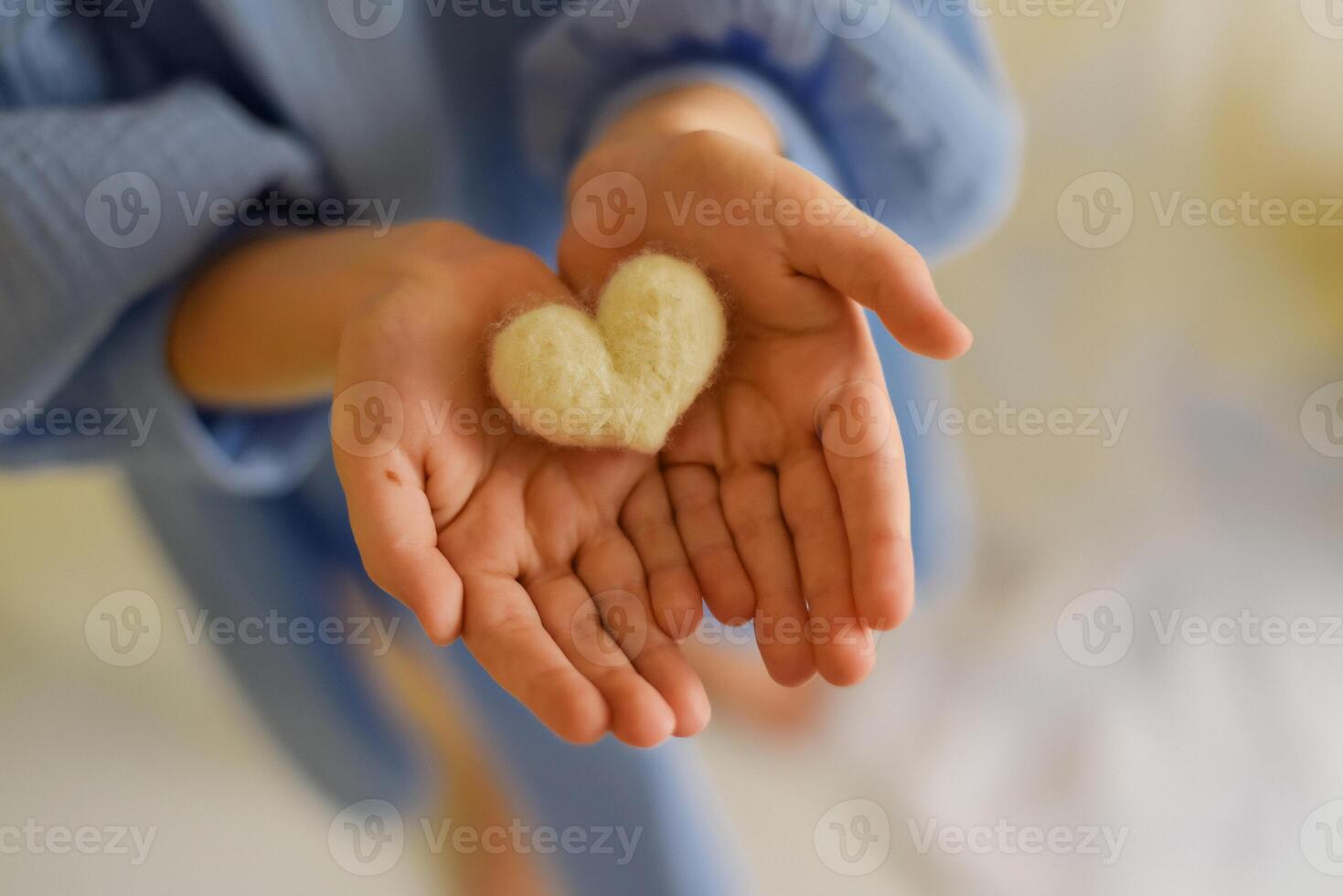 A person holding a heart shaped object photo