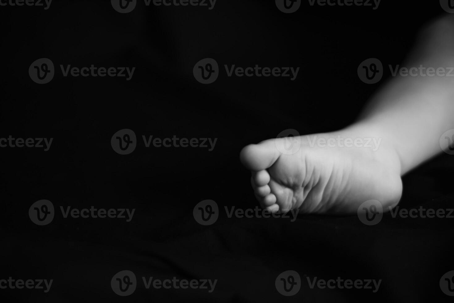 A black and white photo of a baby's feet