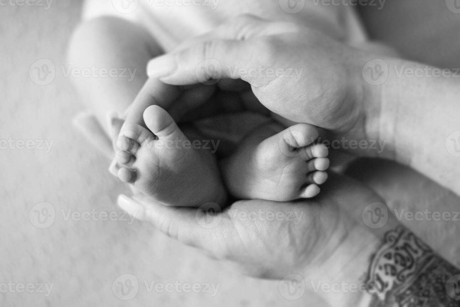 A black and white photo of a baby's feet