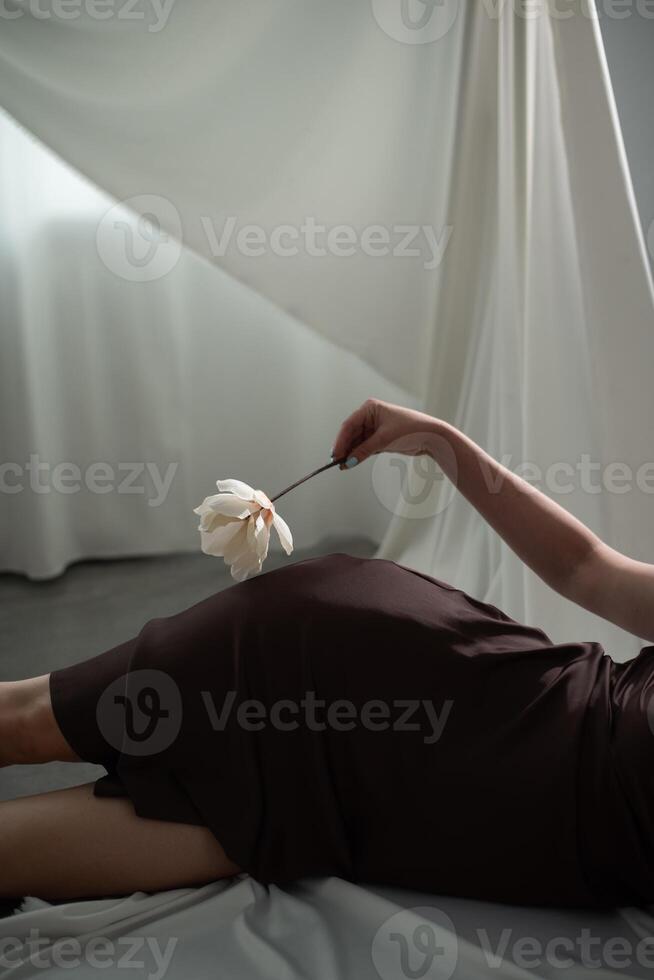 A woman laying on a bed with a flower photo