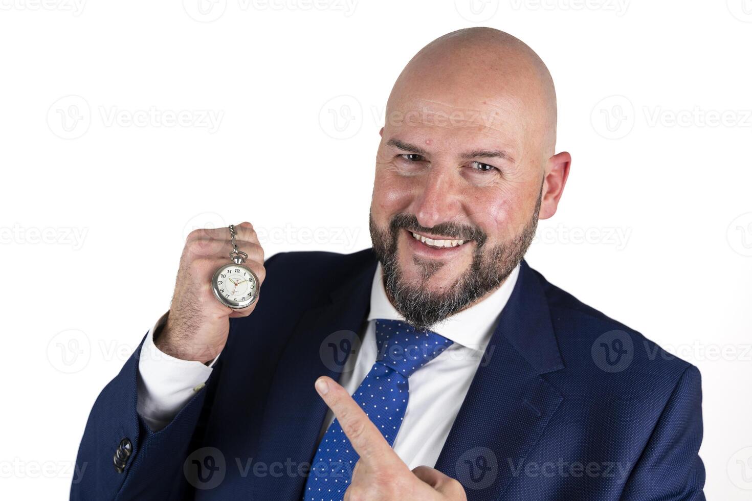 portrait of businessman in blue suit and tie with friendly expression showing pocket watch isolated on white background photo