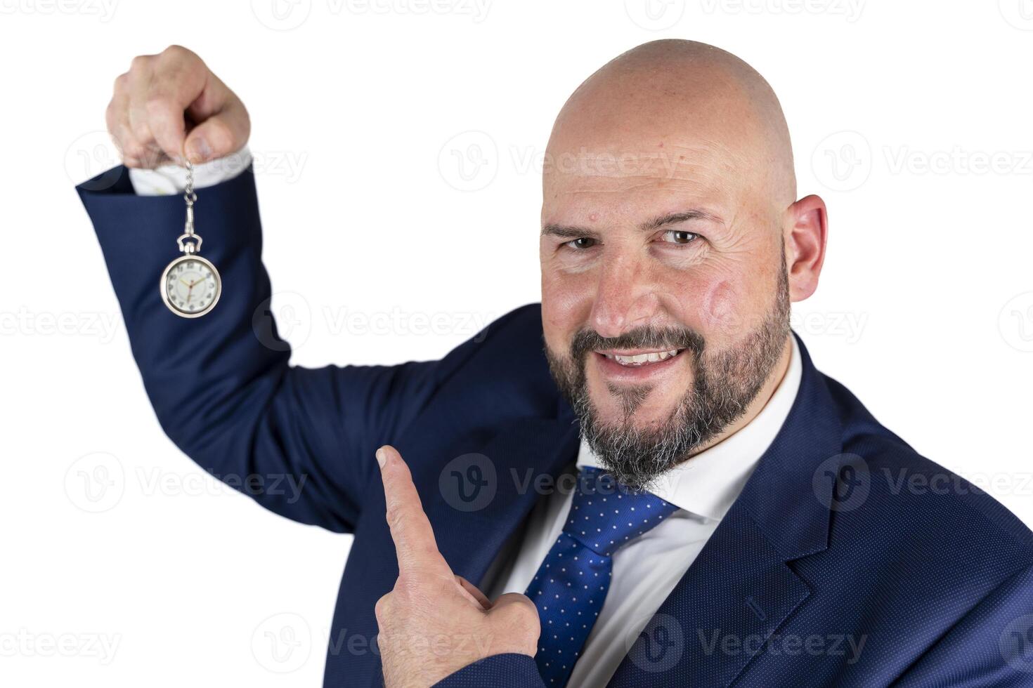 portrait of businessman in blue suit and tie with friendly expression showing pocket watch isolated on white background photo