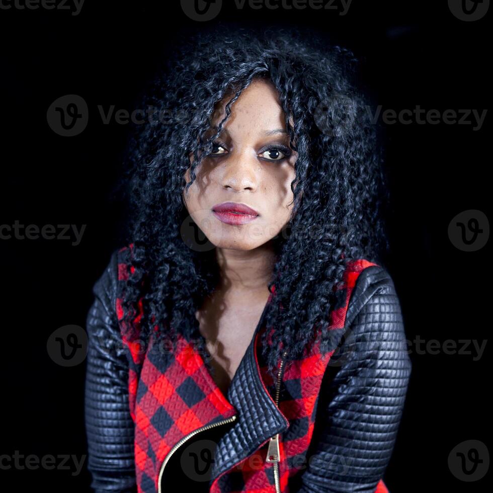 portrait of beautiful young african american girl wearing leather jacket photo
