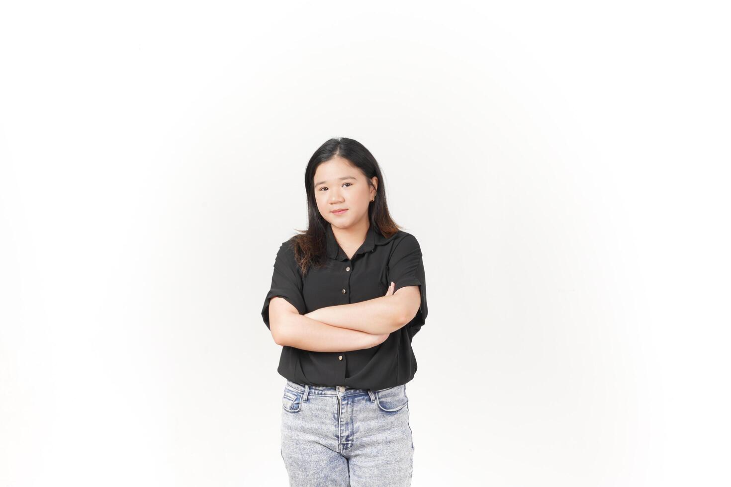 beautiful Asian woman stands with her arms folded across her chest, exuding confidence against a white background photo