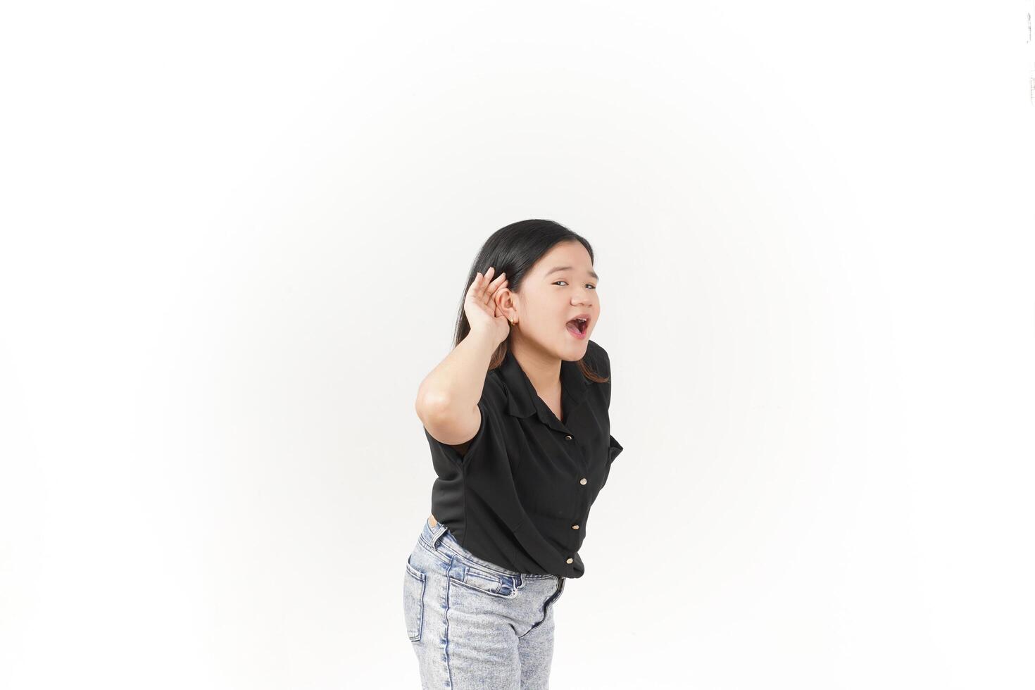 beautiful Asian woman poses with her hands on both ears, trying to listen attentively against a white background photo