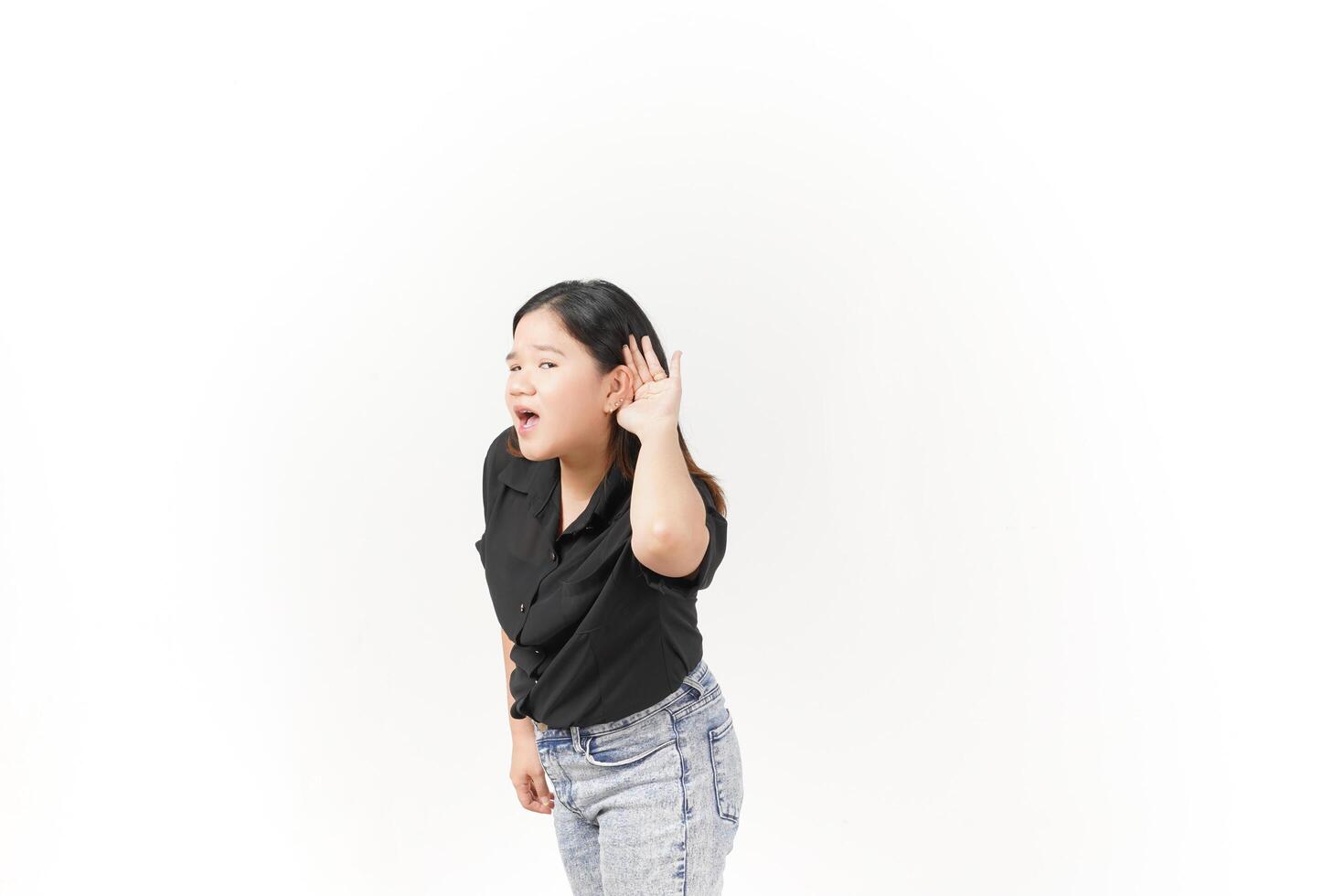 beautiful Asian woman poses with her hands on both ears, trying to listen attentively against a white background photo