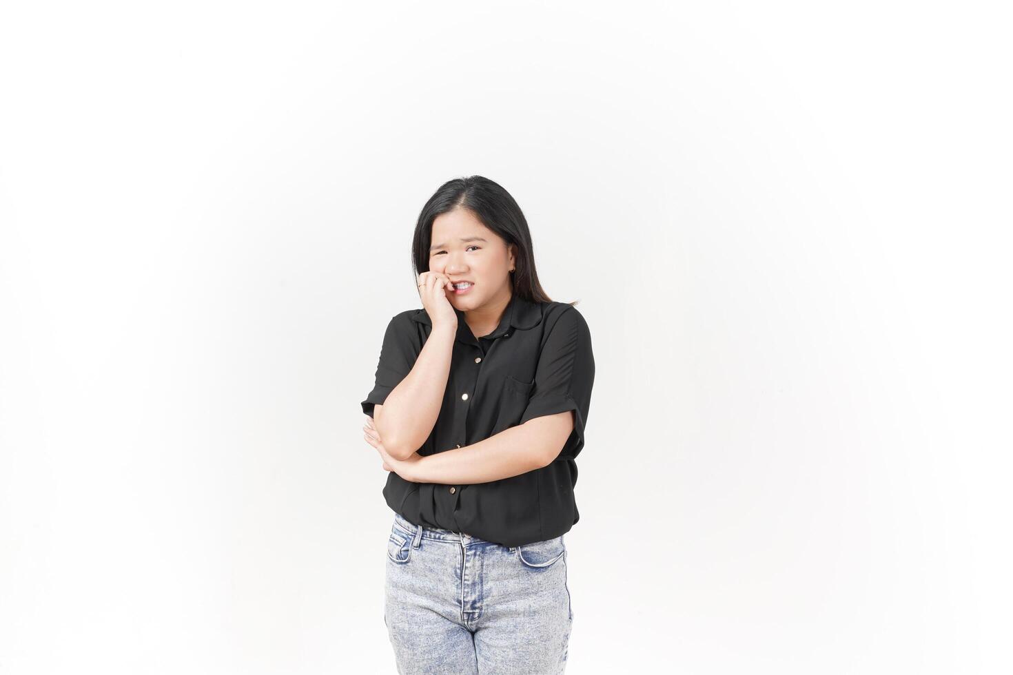 beautiful Asian woman looks scared, worried, and nervous, her expression full of anxiety against a white background photo