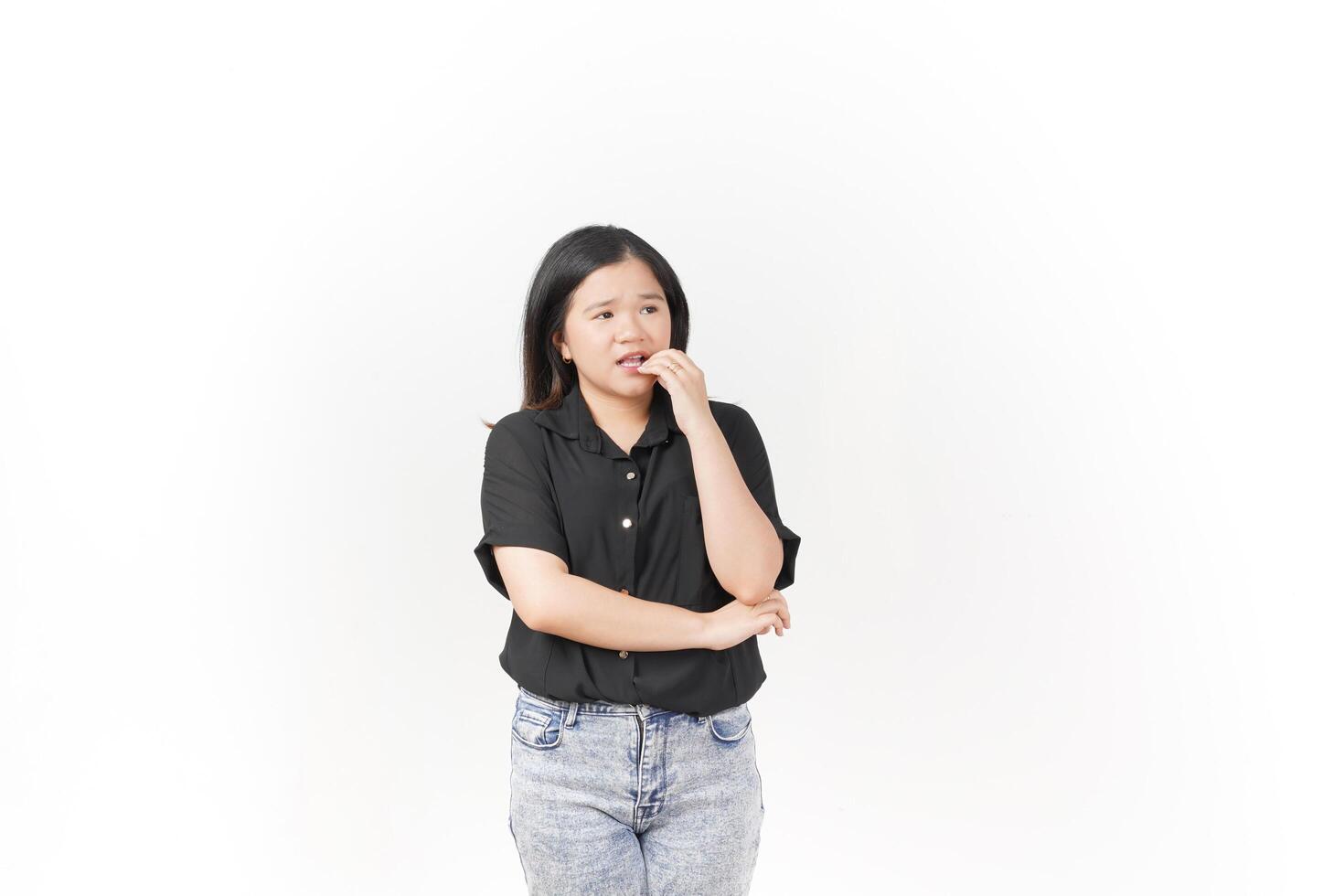 beautiful Asian woman looks scared, worried, and nervous, her expression full of anxiety against a white background photo