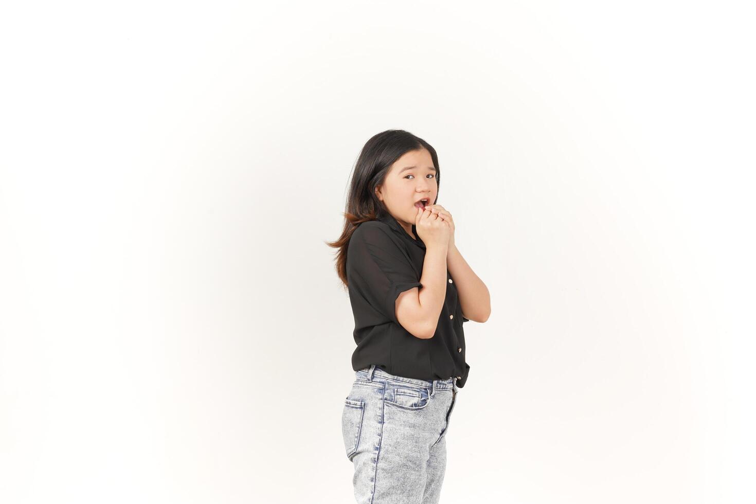 beautiful Asian woman looks scared, worried, and nervous, her expression full of anxiety against a white background photo