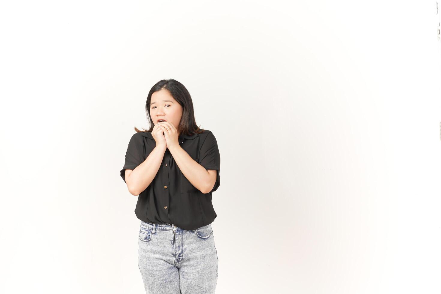 beautiful Asian woman looks scared, worried, and nervous, her expression full of anxiety against a white background photo