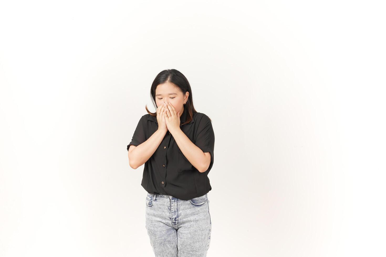 beautiful Asian woman appears to sneeze, displaying allergy symptoms with a hand covering her nose, set against a white background photo