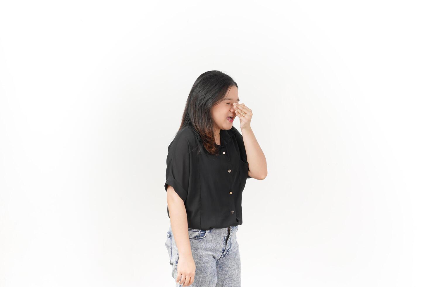 beautiful Asian woman appears to sneeze, displaying allergy symptoms with a hand covering her nose, set against a white background photo