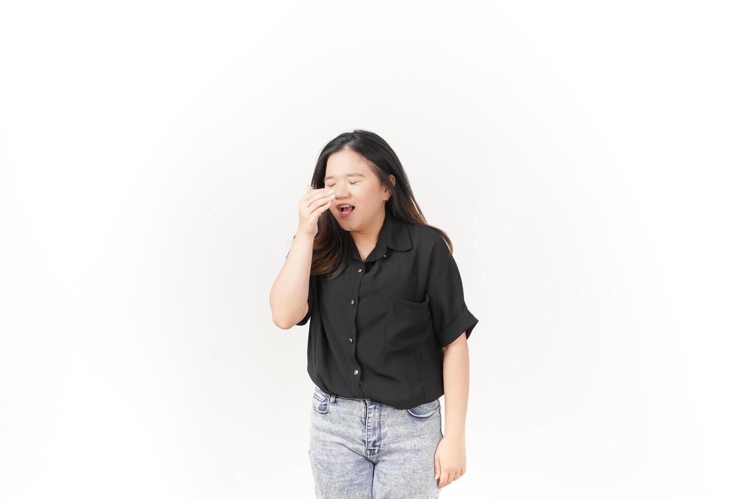 beautiful Asian woman appears to sneeze, displaying allergy symptoms with a hand covering her nose, set against a white background photo