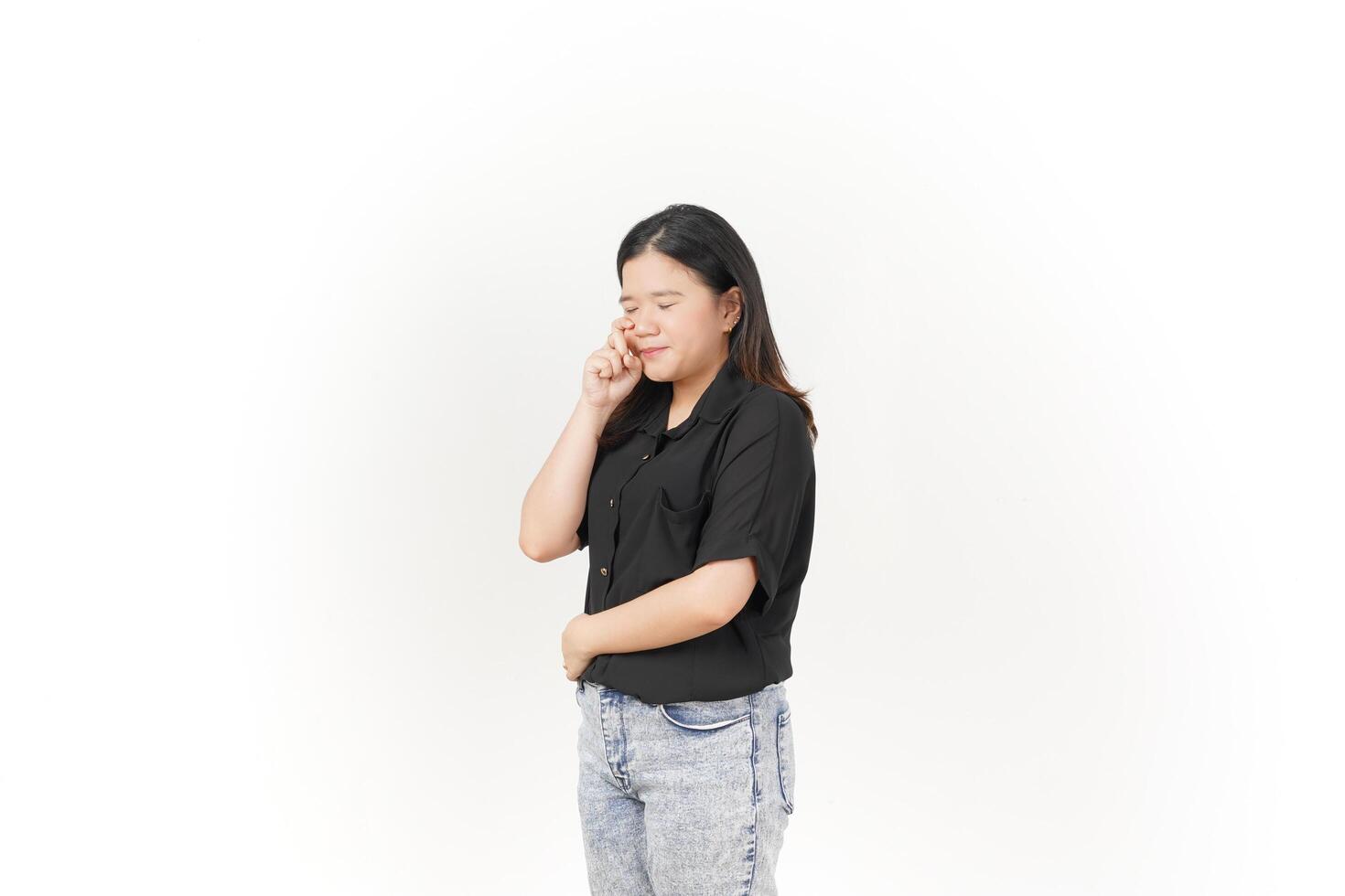 beautiful Asian woman poses with her fingers under her eyes, capturing a poignant crying expression against a white background photo