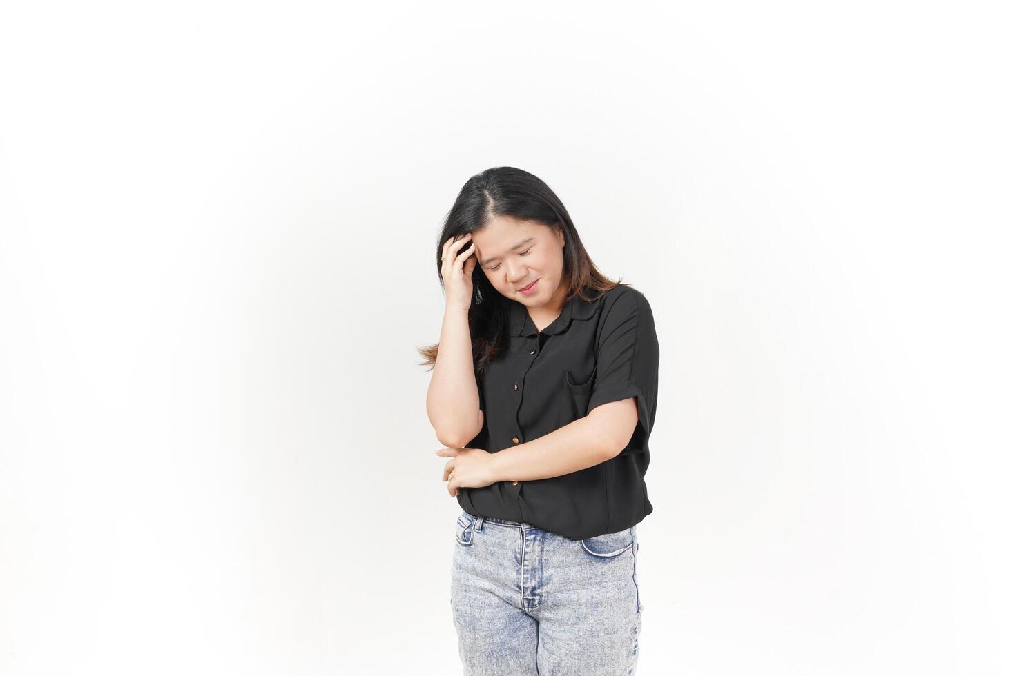 beautiful Asian woman holds her head in a headache pose, expressing discomfort against a white background photo