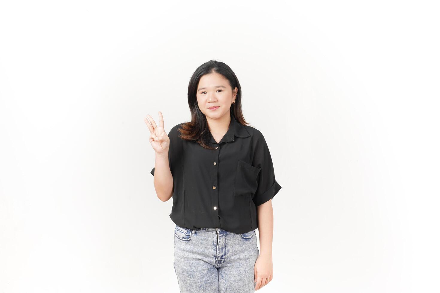 beautiful Asian woman poses, displaying the number three with her fingers against a white background photo