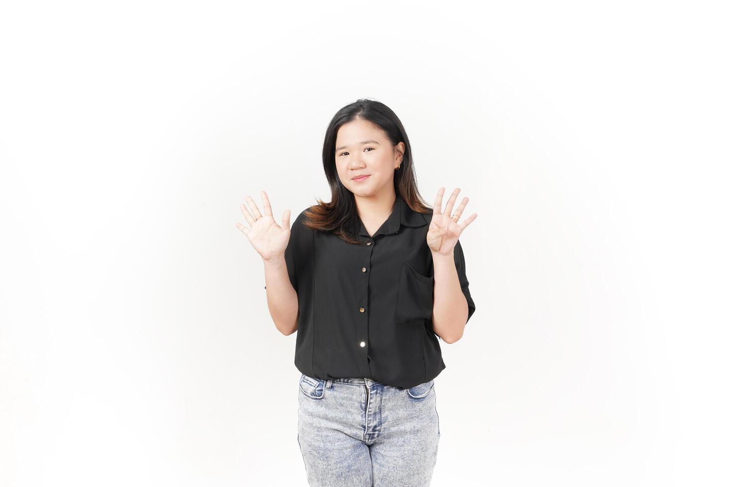 beautiful Asian woman poses with her hands to display the number 9 against a clean white background photo