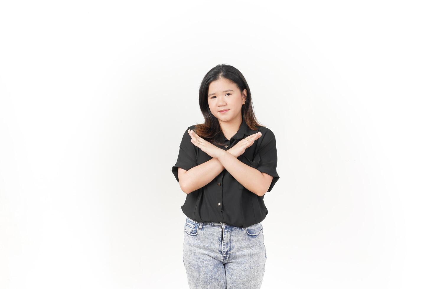 beautiful Asian woman poses with her hands raised in a 'no' gesture against a clean white background photo