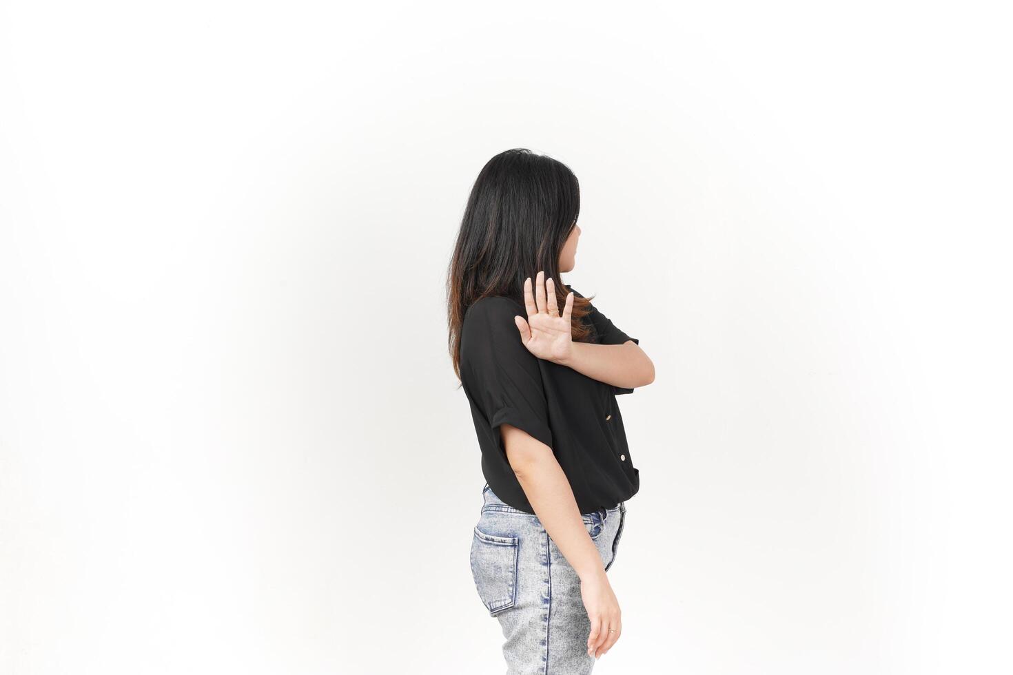 beautiful Asian woman poses with her hands raised in a 'no' gesture against a clean white background photo