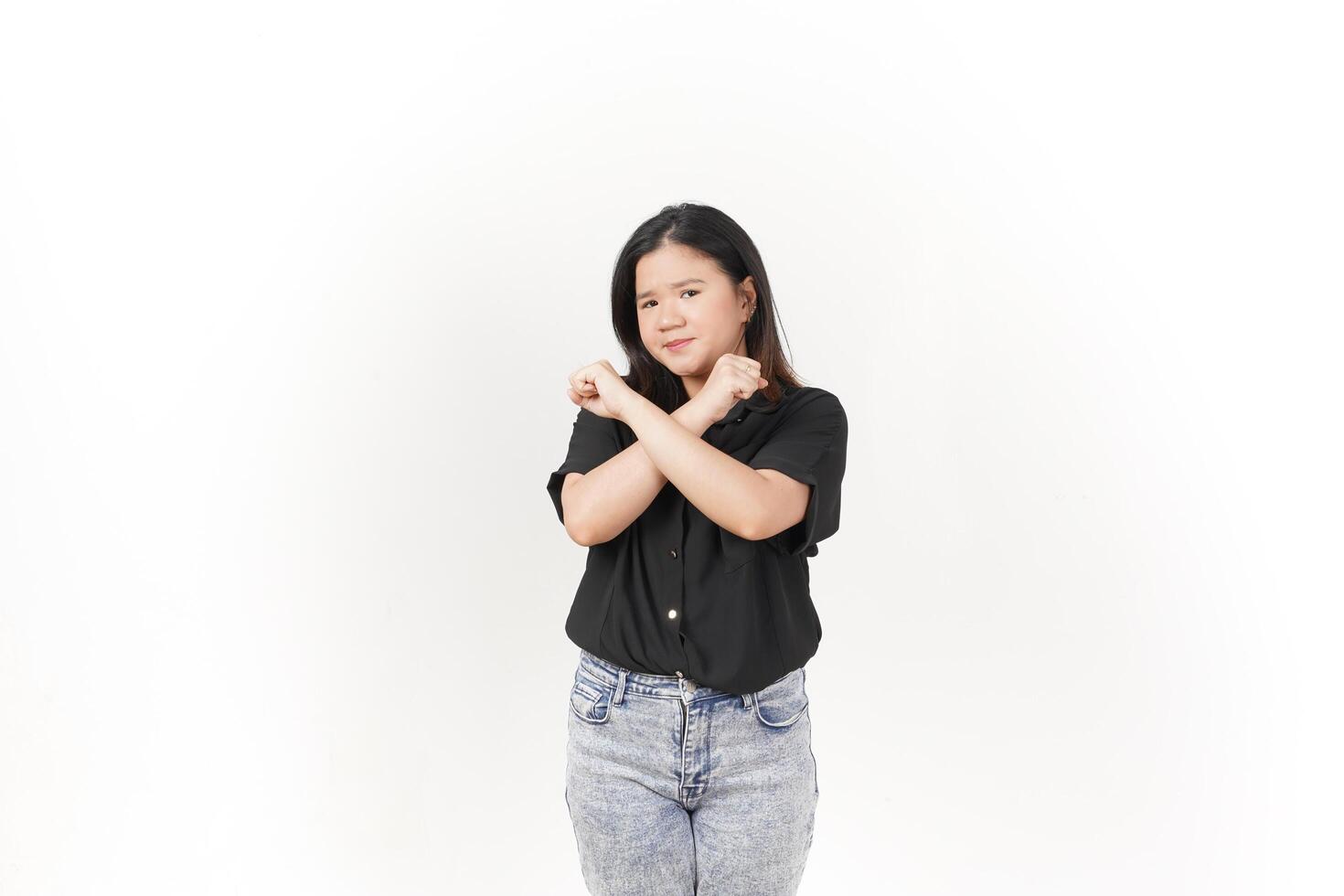 beautiful Asian woman poses with her hands raised in a 'no' gesture against a clean white background photo
