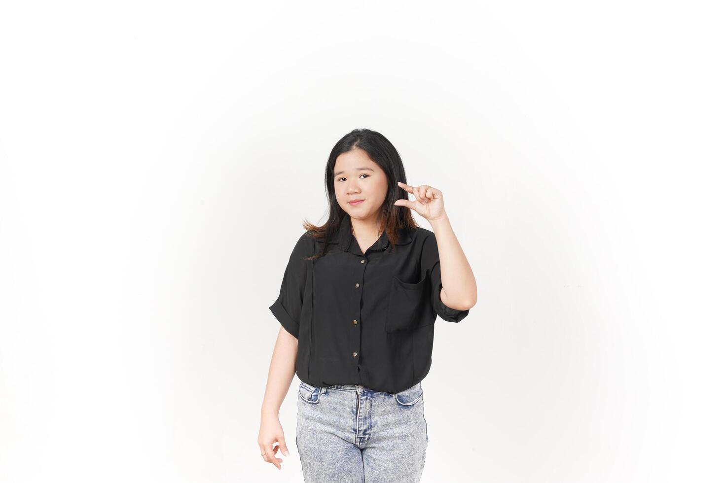beautiful Asian woman displays a small empty product between two fingers against a clean white background photo