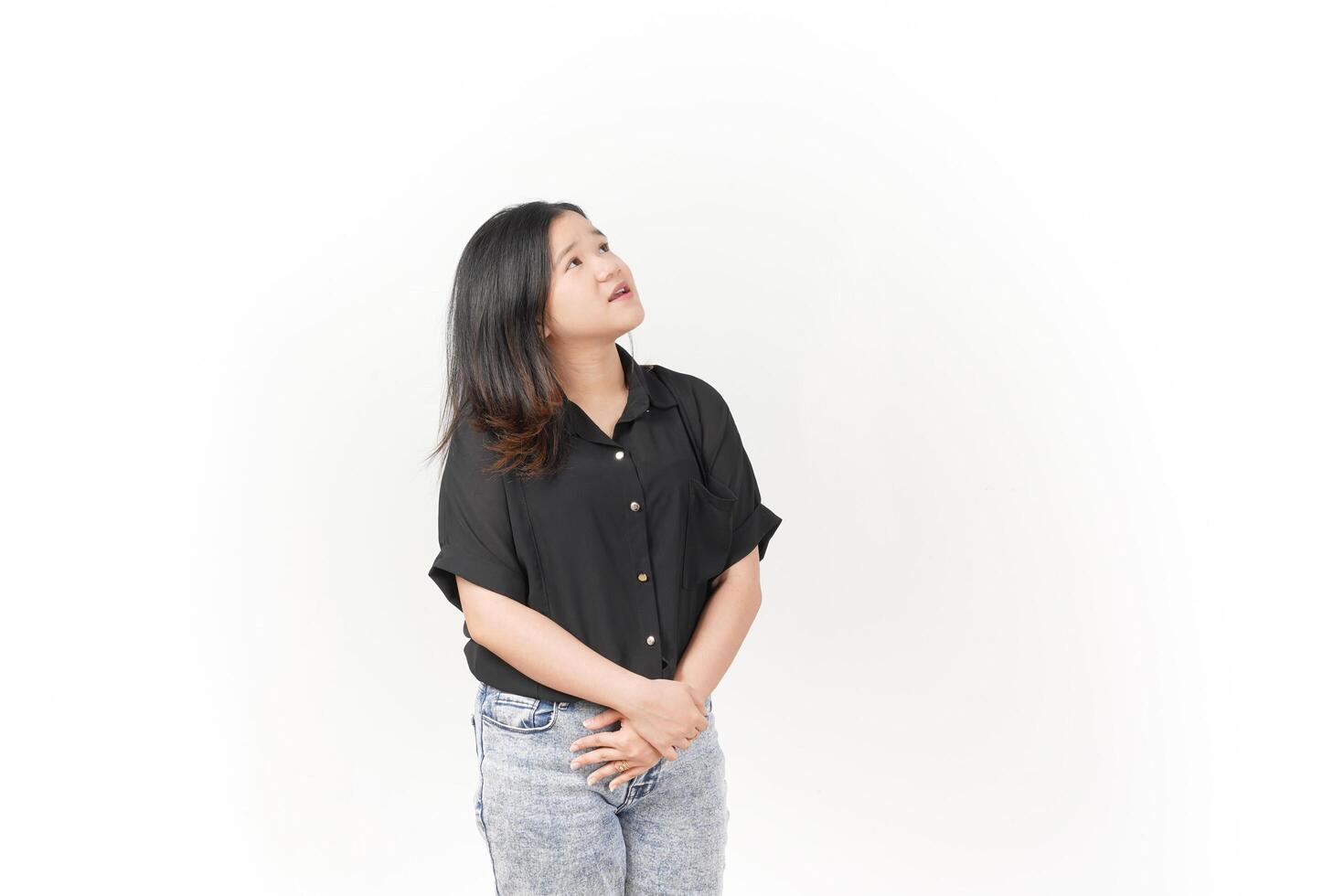 beautiful Asian woman stands in a thoughtful pose, lost in contemplation against a white background photo