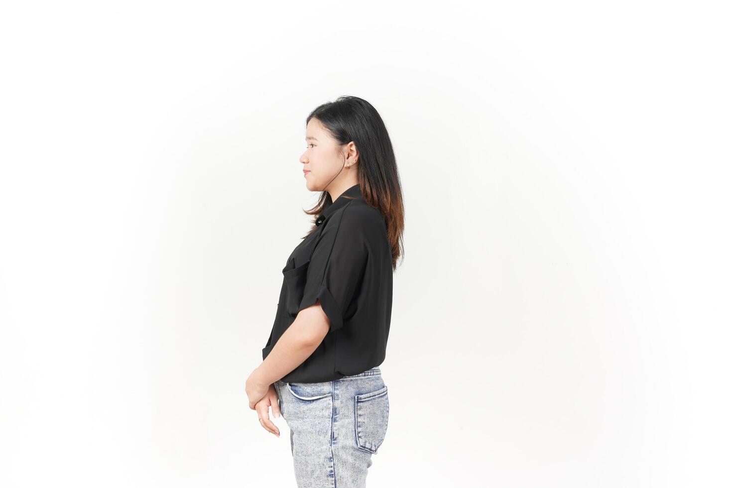 beautiful Asian woman stands in a thoughtful pose, lost in contemplation against a white background photo