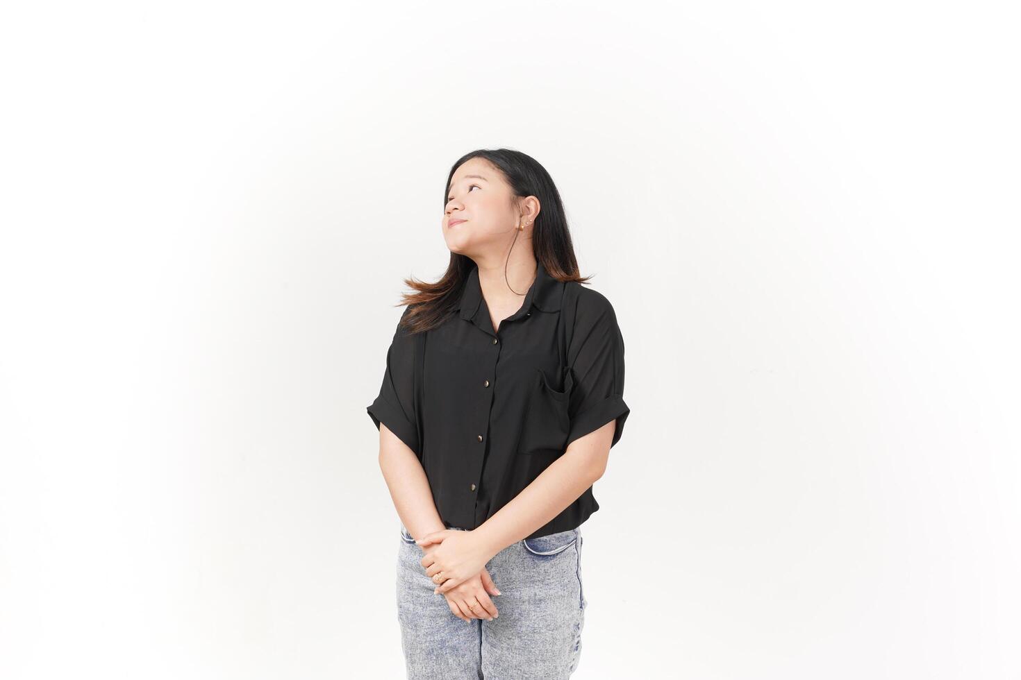 beautiful Asian woman stands in a thoughtful pose, lost in contemplation against a white background photo