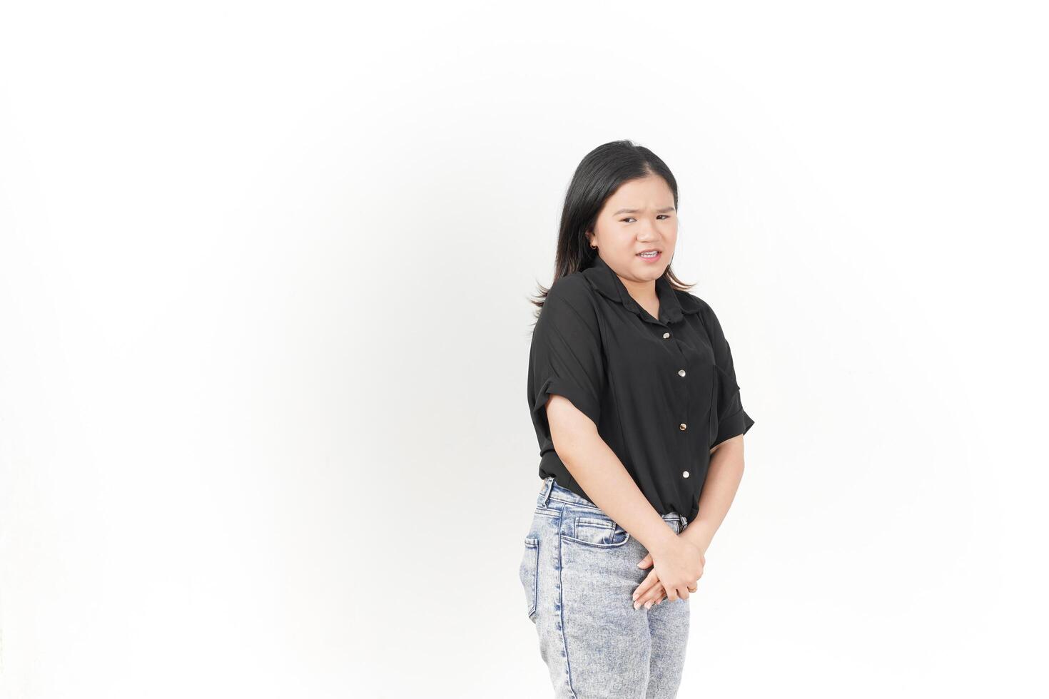 beautiful Asian woman stands gracefully, looking down thoughtfully against a clean white background photo