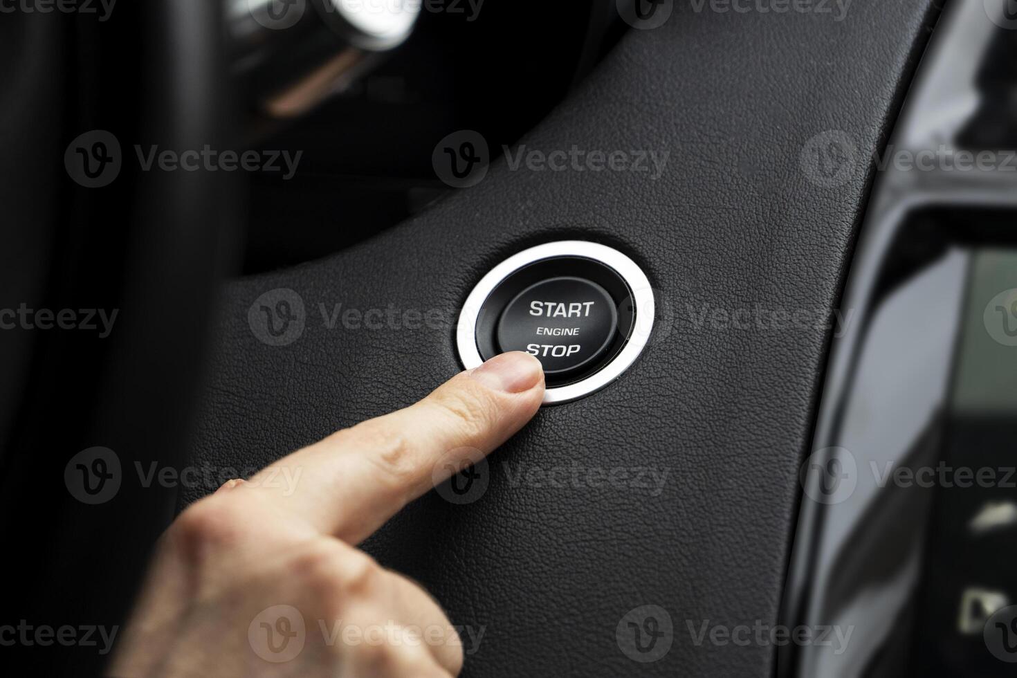 Women activates button to start and stop for car engine, pressing start engine button on a modern sports car photo